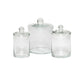 The Darby Clear Canister Collection by Pigeon & Poodle features three glass jars with round-handled lids in assorted sizes, ideal for bathroom organization or versatile storage. Displayed on a plain white background.