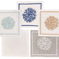 The Haute Home Sea Sponge Coaster Set includes 4 linen coasters, each hand embroidered with coral designs in blue, beige, light blue, white, and gray for a refined touch at your gatherings.
