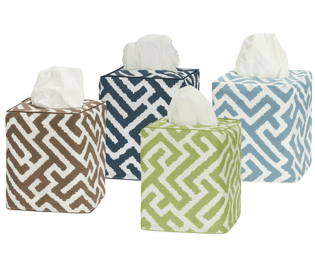 The Gabriel Tissue Box Cover Collection by Matouk features four square covers with geometric patterns in brown, navy blue, green, and light blue—each a stylish touch for your bathroom decor.