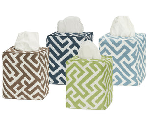The Gabriel Tissue Box Cover Collection by Matouk features four square covers with geometric patterns in brown, navy blue, green, and light blue—each a stylish touch for your bathroom decor.