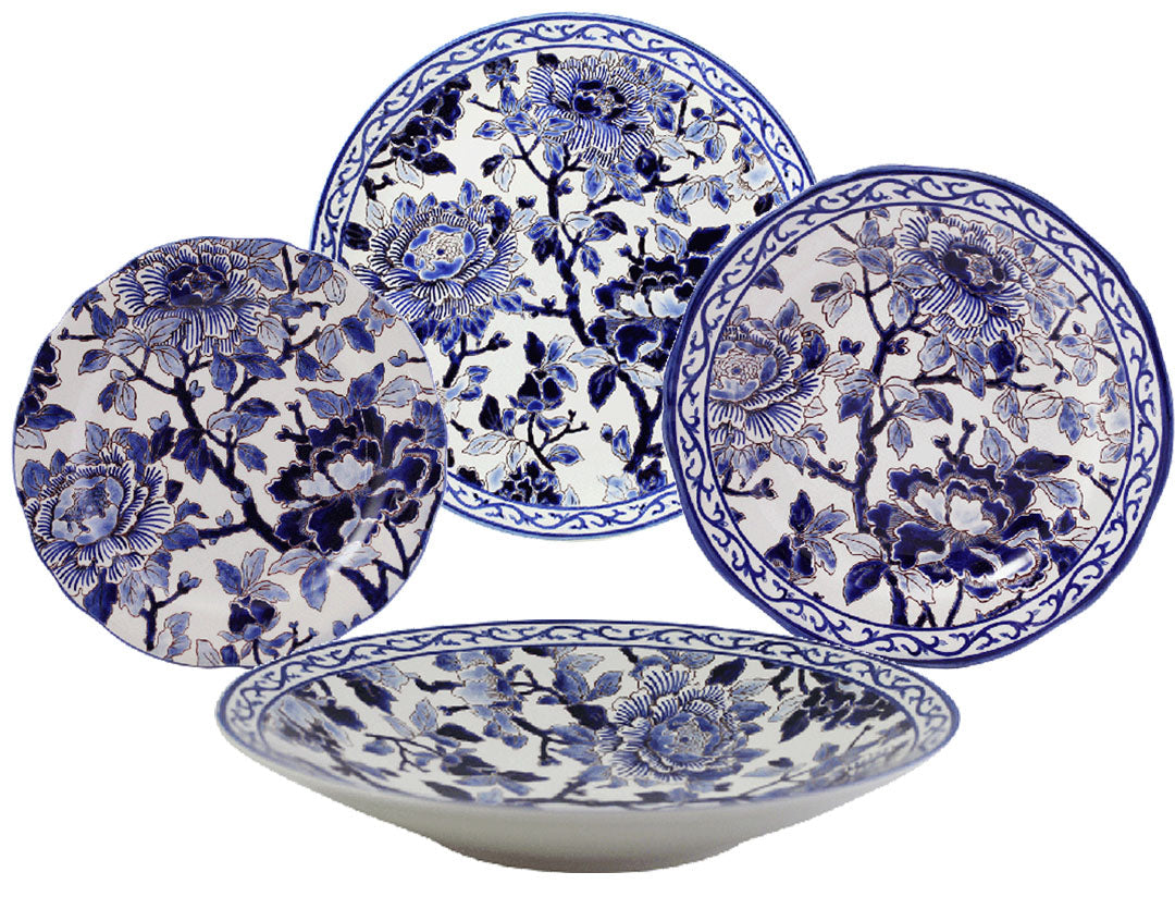 Four ceramic plates from the Pivoines Bleues Dinnerware and Serveware Collection by Gien France showcase intricate blue peony-inspired floral designs, with two at the back, one at the front, and one to the left.