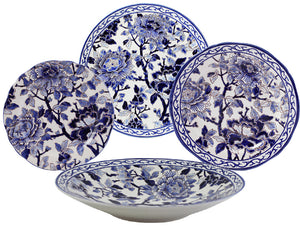Four ceramic plates from the Pivoines Bleues Dinnerware and Serveware Collection by Gien France showcase intricate blue peony-inspired floral designs, with two at the back, one at the front, and one to the left.