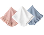 The Juliska Mademoiselle Napkin Set features three folded napkins with knife-pleat ruffle borders in pink, white, and blue, arranged side by side on a white background—ideal for a romantic tablescape.