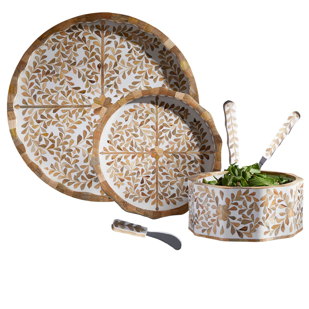 The Mya Inlay Serving and Decor Collection by Be Home features a brown and white leafy pattern, including two plates, a salad bowl with salad, two mother of pearl inlay serving spoons, and a spreader knife.