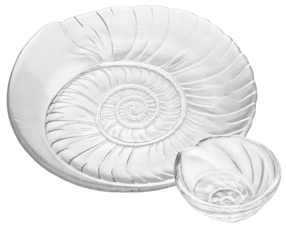 The Simon Pearce Shell Serveware Collection features large and small clear glass dishes with embossed spiral shell patterns—perfect for beach-inspired decor or a unique summer host gift.