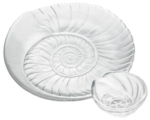 The Simon Pearce Shell Serveware Collection features large and small clear glass dishes with embossed spiral shell patterns—perfect for beach-inspired decor or a unique summer host gift.