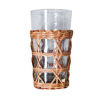 The Be Home Seagrass Rattan Cage Tumbler, from the Seagrass Rattan Cage Tumbler Collection, features a clear glass with a woven wicker holder around its base, adding rustic charm and shown against a plain white background.