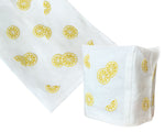 From Haute Home's Lemon Slice Bath Collection: a white Italian linen cloth and fabric tissue box cover, both featuring hand-embroidered yellow lemon slice motifs.