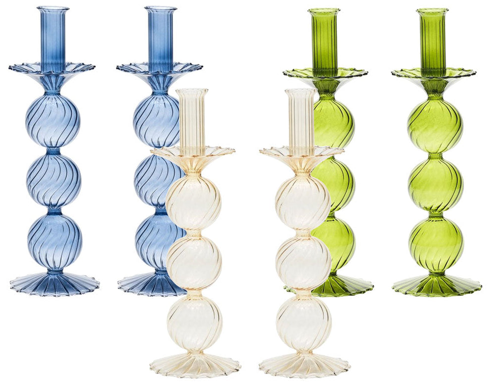 The Kim Seybert Iris Tall Candle Holder Set features five ribbed, hand-blown glass candlestick holders with stacked spheres and scalloped bases in blue, clear, and green, displayed upright against a white background.