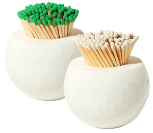 Two round white containers from the Tart by Taylor Golf Match Striker Collection hold matches—one with green tips, one with white tips.