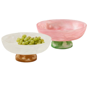 Two Benno Large Fruit Bowls by Blue Pheasant—one white with a brown base filled with green grapes, the other pink with a green base—are arranged side by side on a white background.
