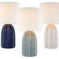 Three Melanie Large Table Lamps by Visual Comfort, featuring white silk shades and ceramic bases in navy blue, light blue, and white with reactive ceramic glazes, are displayed side by side against a white background.