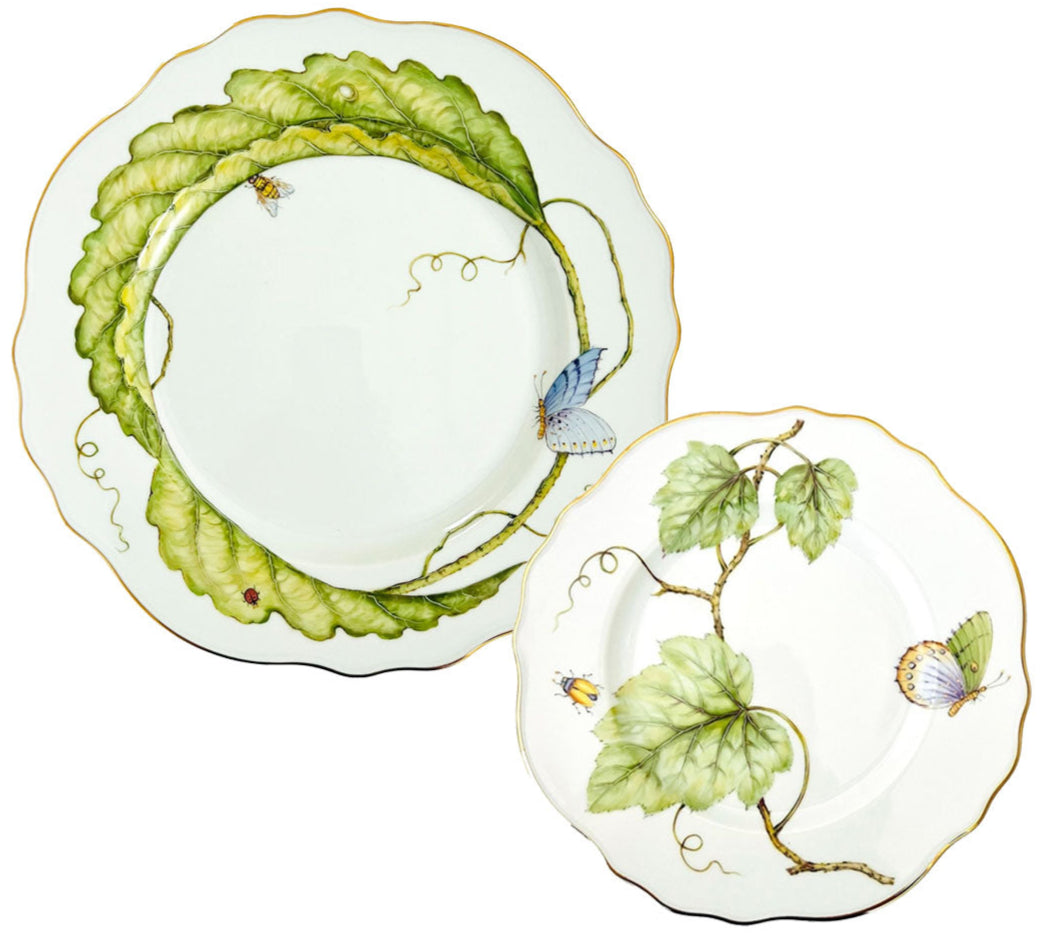 From the Garden Leaves Dinnerware Collection by Anna Weatherley, these two hand-painted porcelain plates feature scalloped edges, green leaf motifs, butterflies, insects, and elegant gold trim.