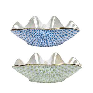 Herend’s Clam Shell Collection includes two white porcelain bowls with scalloped edges, each hand painted with geometric patterns—one in blue, one in green—for a decorative accent.