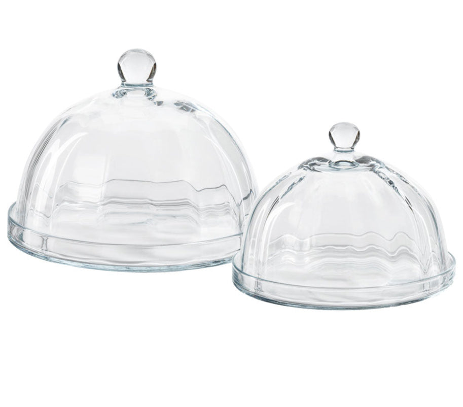 The Zodax Loulou Optic Pastry Glass Plates feature clear glass cloches with knobs and matching round bases, ideal for displaying desserts elegantly against a white background.