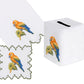 Haute Home Parrot Coaster & Bath Collection items including a square tissue box cover, a square coaster, and a hand towel, each embroidered with a colorful parrot perched on a branch.