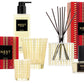 Celebrate with the NEST Holiday Collection by Nest, featuring a scented candle, reed diffuser, hand soap, and fragrance—all in festive gold and red packaging with their signature Holiday scent.