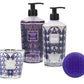 The Baobab Manhattan Body Wellness Collection includes a candle, shower gel, body cream, and round purple soap in purple and silver packaging with a fresh scent inspired by Central Park's vibrant energy.