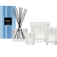 The Nest Blue Cypress & Snow Collection features a reed diffuser, three white winter candles in patterned glass holders, all presented in a blue patterned box.