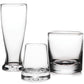 Three clear, empty glass cups of various shapes and sizes from the Simon Pearce Ascutney Drinkware Collection are displayed against a plain white background, highlighting this exquisite handmade barware.