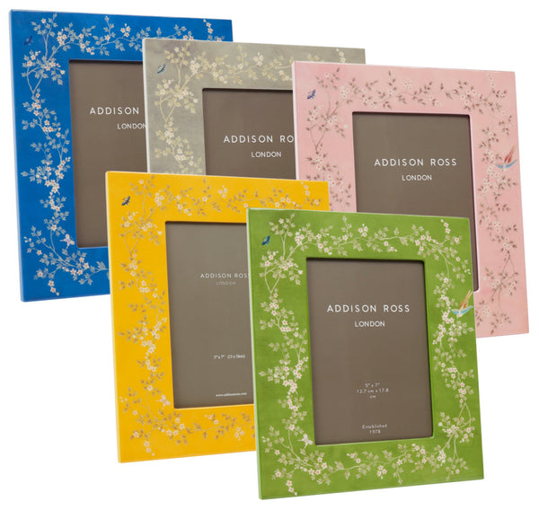 Five frames from the Addison Ross Chinoiserie Frame Collection, in blue, yellow, gray, green, and pink with a floral pattern and high-gloss lacquer finish are elegantly displayed upright.