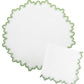 The Wave Tabletop Collection, Santorini by Matouk features round and square white linen napkins with wavy green-edged borders, OEKO-TEX certified—perfect for layering on embroidered tabletops.