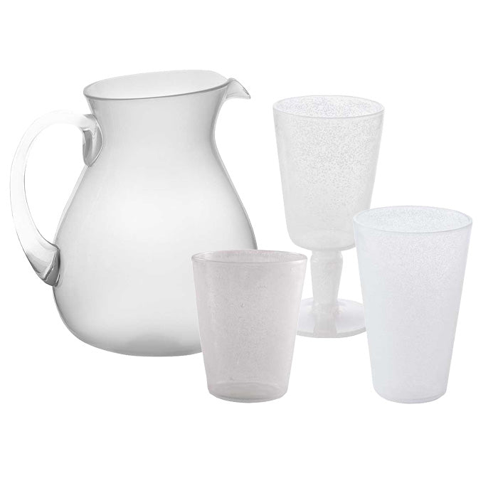 The Memento White Acrylic Drinkware Collection features a clear pitcher with handle and three transparent glasses of varying shapes and sizes—functional, stylish acrylic pieces ideal for outdoor dining.