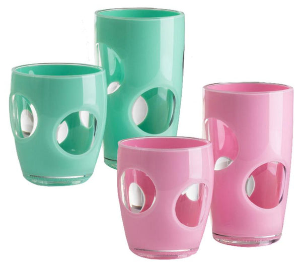 A set of four glass tumblers from the Mario Luca Giusti Fisheye Acrylic Collection features a charming circular cut-out design, with two in turquoise and two in pink. Ideal for an outdoor table setting, this collection by Mario Luca Giusti adds a stylish and vibrant touch to any occasion.