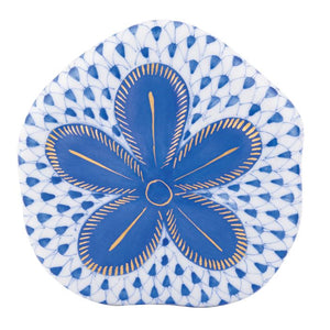 The Herend Puffy Sand Dollar is a collectible porcelain plate with a blue and white pattern, featuring a large blue flower with yellow accents at the center—an elegant decorative accent for any setting.