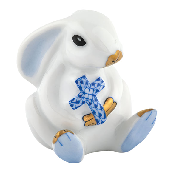 The Herend Bunny with Cross figurine, by Herend, is a hand-painted porcelain rabbit adorned with blue and gold accents, cradling a cross with a blue pattern—an exquisite artistic creation.