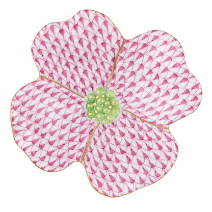 The Herend Dogwood Flower is a decorative pink and white porcelain plate with a green textured center and gold accents, showcasing Herend's hand-painted designs that inspire artistic appreciation.