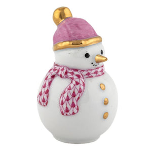 The Herend Snowman features a porcelain design with a gold nose and buttons, pink hat, and patterned scarf—a collectible piece that brings timeless elegance to any decorative accent display.