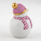 The Herend Snowman is a white ceramic figurine with a pink and gold hat and patterned pink scarf, making this collectible porcelain a timeless decorative accent against a plain white background.