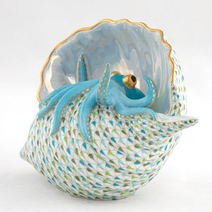 Herend Reserve Collection Multicolor Octopus in Shell: Porcelain figurine of a vibrant octopus nestled in a shell, detailed with white, green, and blue scale-like patterns and shimmering pearlized paint.
