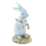 The Herend Reserve Collection Anniversary Bunny is a limited edition ceramic figurine featuring a blue patterned rabbit holding a bird, standing on a decorated floral and fan base with exquisite hand-painted designs inspired by Herend porcelain.