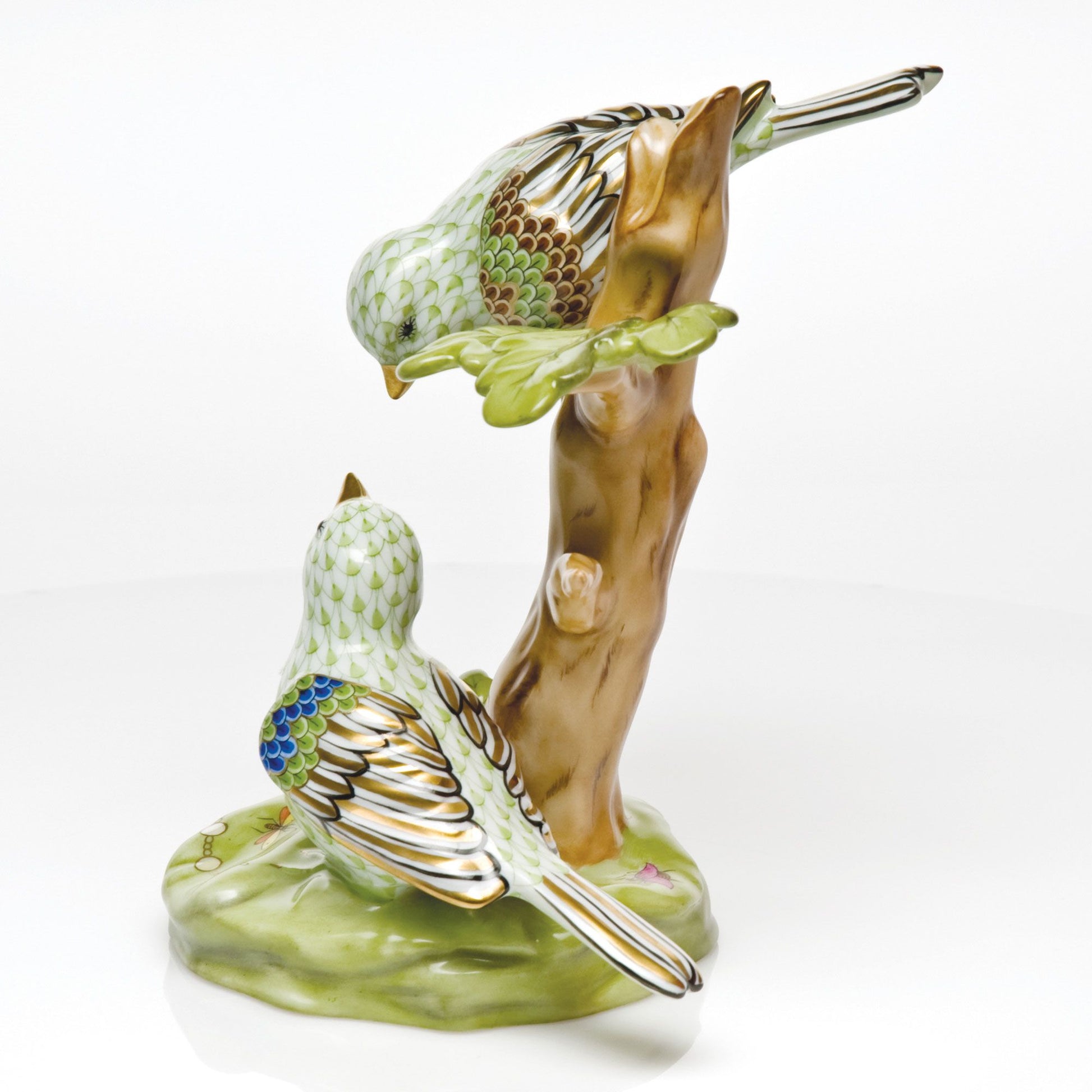Herend Reserve Collection The Rothschild Birds figurine features two songbirds perched on a branch, one looking up, the other down, in green, blue, and brown. A charming limited edition collectible for any collection.