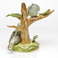 The Herend Reserve Collection The Rothschild Birds is a limited edition porcelain figurine featuring two green patterned birds on a brown tree with a green base—a must-have collectible for songbird enthusiasts and nature lovers.