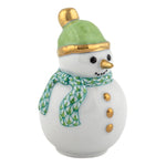 The Herend Snowman features a gold nose and buttons, a green hat with gold trim, and a green patterned scarf—a charming ceramic accent to bring timeless elegance to your holiday decor.