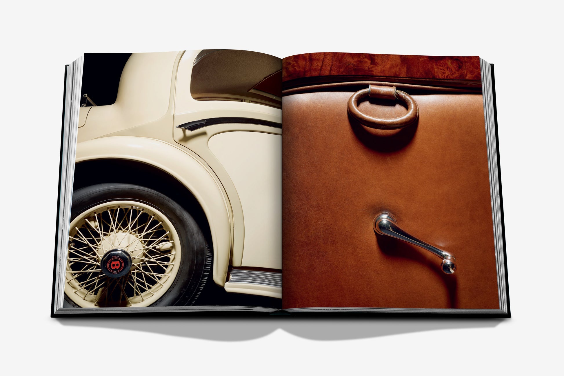 An open spread of Assouline's "Vintage Cars (2nd Edition)" showcases a detailed close-up of a classic car’s rear wheel on the left page and a brown leather car door with its handle on the right, beautifully embodying the essence of luxury automotive photography.