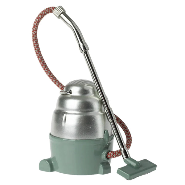 The Maileg Vacuum Cleaner, a vintage gem from Maileg, features a silver top, green base, flexible hose, and long handle—ideal for ensuring your mice's little home remains spotless.