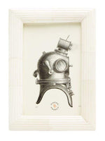 From the Velden Frame Collection by Pigeon & Poodle, this framed illustration of an antique deep-sea diving helmet with hand-etched ribbing features "Pigeon Trouble" printed below the image.