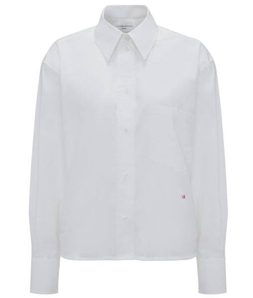 A Victoria Beckham Cropped Long Sleeve Shirt with red buttons, made of organic cotton.