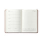 The Graphic Image 2026 Weekly Journal Planner Collection shows a leather notebook open to July 15–21, with lined daily sections and a mini monthly calendar at the bottom right.