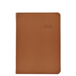 The Graphic Image 2026 Weekly Journal Planner Collection features a brown leather notebook with "2026" embossed on the cover, shown closed against a white background.