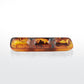 The Nashi Home Tortoise Resin Serveware Collection features an amber-hued rectangular glass dish with three compartments, shatter resistant and ideal for chic home decor, displayed on a plain white background.
