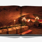 A book open to a photo of a candlelit cave dining setting with tables, chairs, and elegant place settings captures the allure found in "Wine & Travel France" by Assouline, reminiscent of the charm of French vineyards.