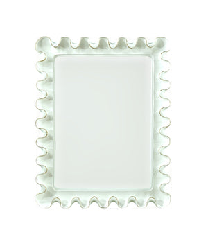 The Wave Moderne Mirror in White by Carvers' Guild features a rectangular beveled glass and a wavy, ruffled frame in an Art Deco style, displayed against a plain white background.