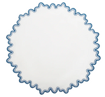 The Matouk Wave Tabletop Collection, Aquarius, features a round white plate with a blue wavy edge—ideal for pairing with linen napkins or an embroidered tablecloth for an elegant dining touch.