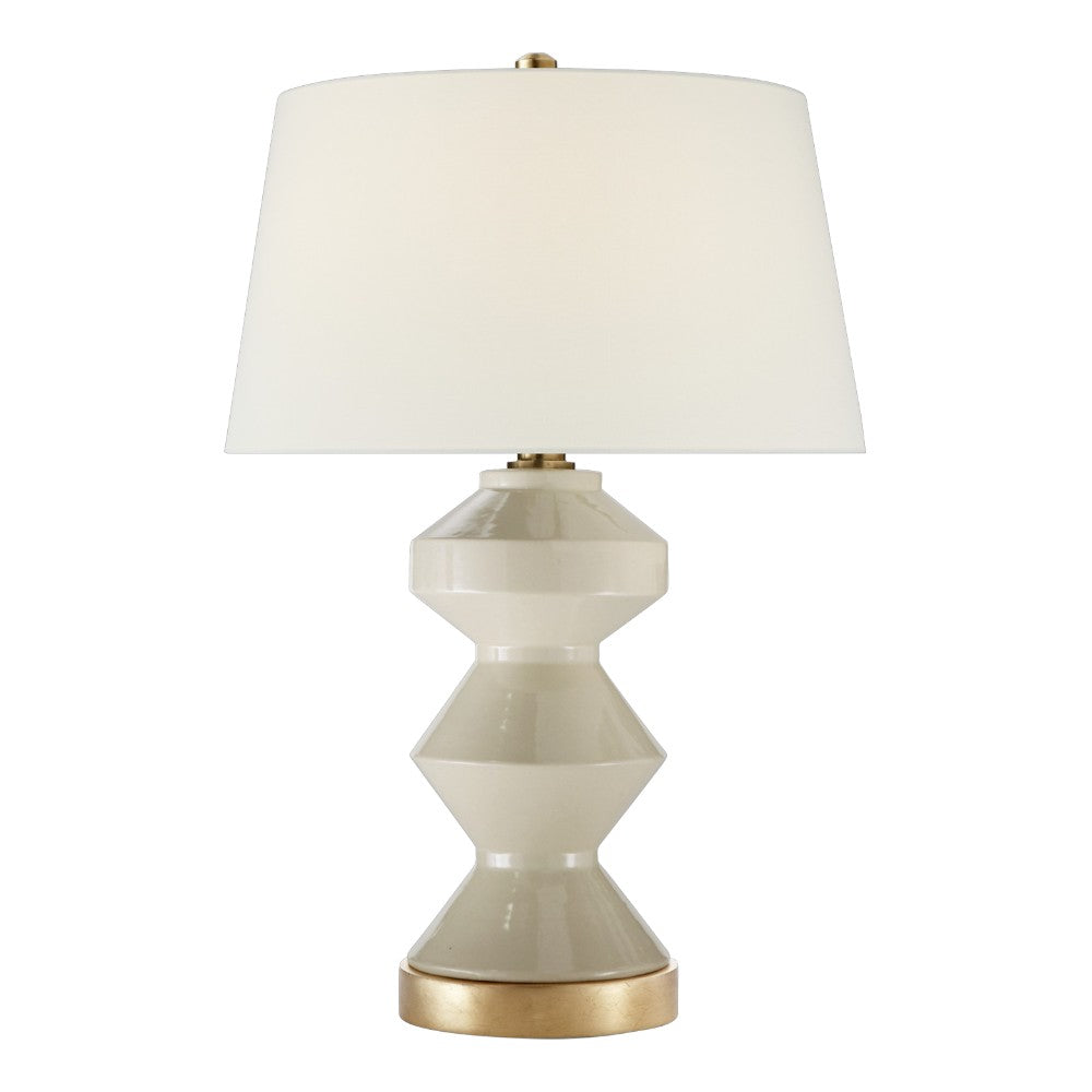 The Weller Zig Zag Lamp in Coconut Porcelain by Visual Comfort features a geometric ceramic base in light beige with gold accents and a subtle pattern, topped with a large white fabric shade for soft light diffusion.