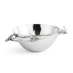 A silver hammered metal bowl from the Michael Aram White Orchid Serveware Collection, featuring decorative branches and flower accents on the rim, evoking purity and subtle mystery.